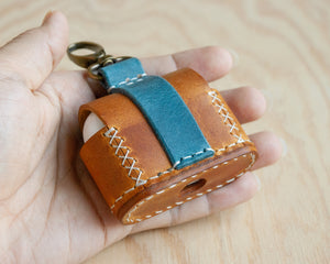 Leather AirPods case on surface, Ravenweave studio