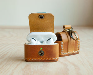 Ravenweave leather AirPods case open, showing interior